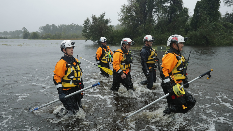 Members of the FEMA Urban Search and Rescue Task Force 4 from Oakland, California, search a flooded neighborhood for evacuees in Fairfield Harbour, North Carolina.